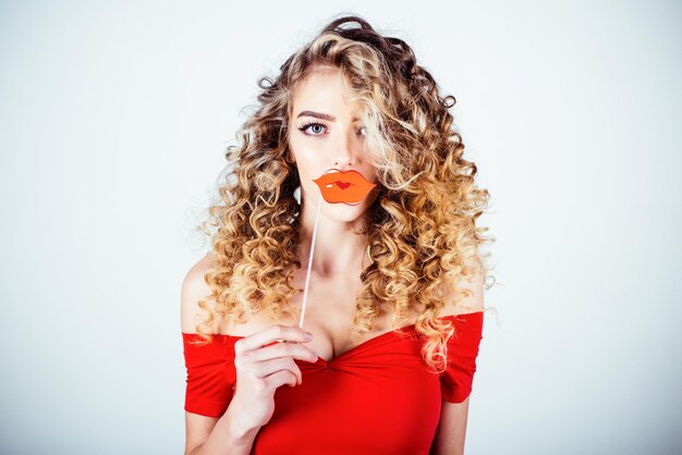 Woman with curly hair portrait of funny positive curly hair girl with lips on stick makeup and