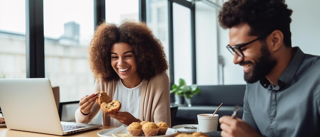 a woman with curly hair sits at a table with a man and woman eating pastries