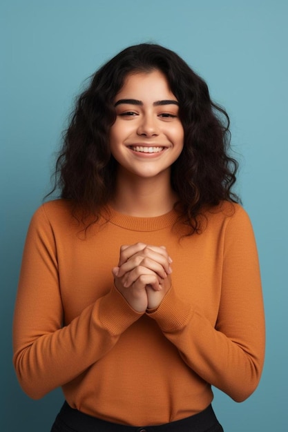 a woman with curly hair wearing an orange shirt