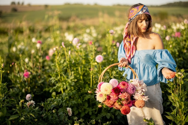 Woman with dahlias at flower farm