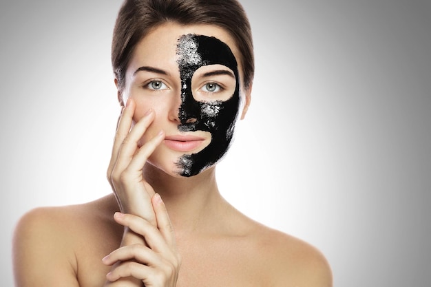 Photo woman with deep cleansing black mask on her face