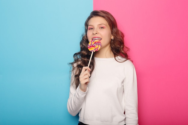 Woman with dental braces holding lollipop