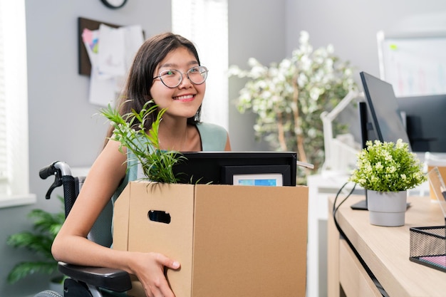 Woman with disability Asian Korean beauty sits use wheelchair at corporate desk