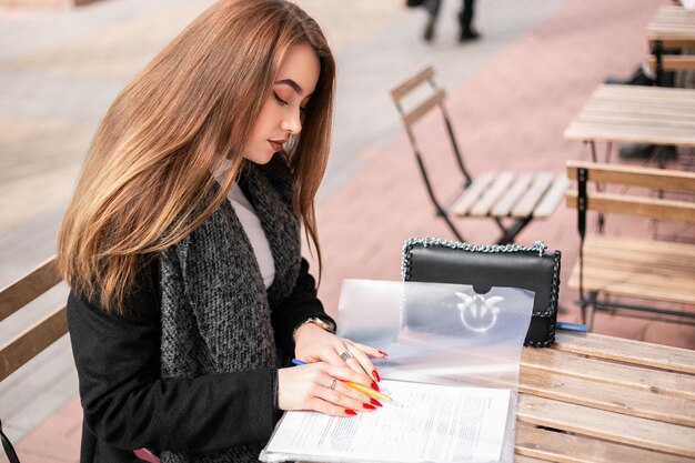 Woman with documents outside