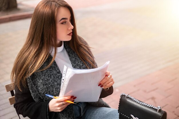 Woman with documents outside