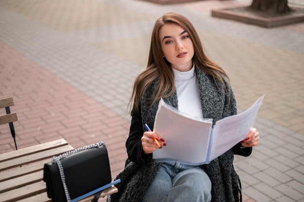 Woman with documents outside