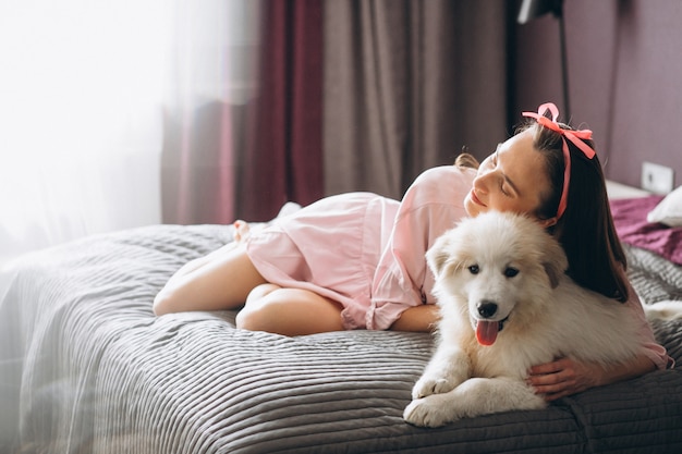 Woman with dog in bed