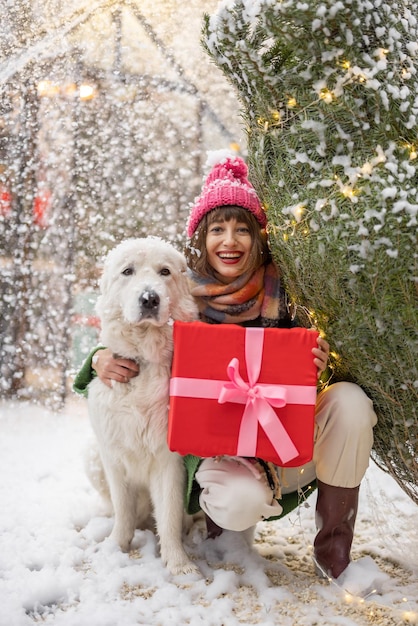 Woman with dog celebrates winter holidays