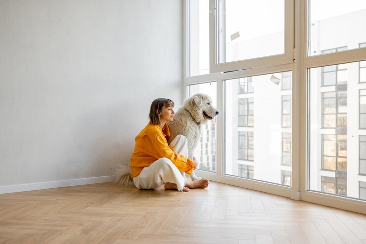 Woman with dog in new apartment