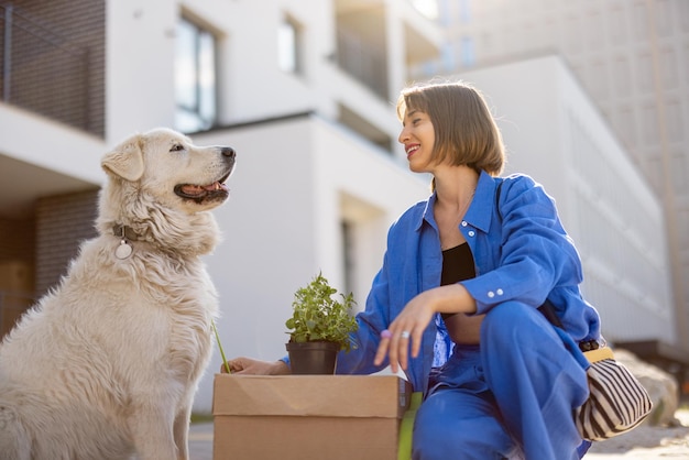 Woman with dog relocating to a new apartment