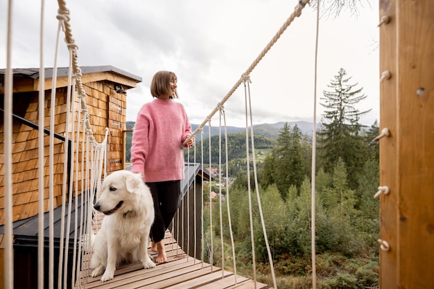 Woman with dog rests in mountains