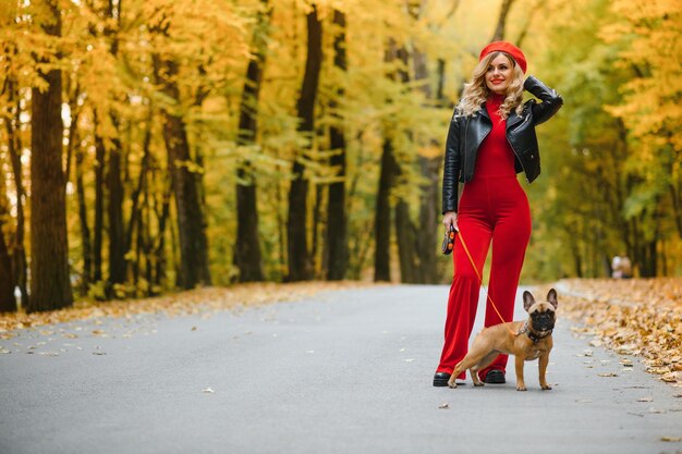 Donna con cane che passeggia nel parco