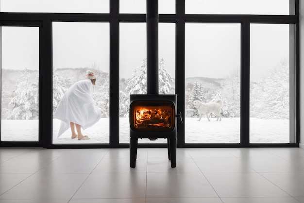 Woman with dogs at house in snowy mountains