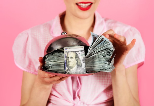 Woman with dollar banknotes on serving tray. Credit. Taxes. Money. Cash. Loan payment.