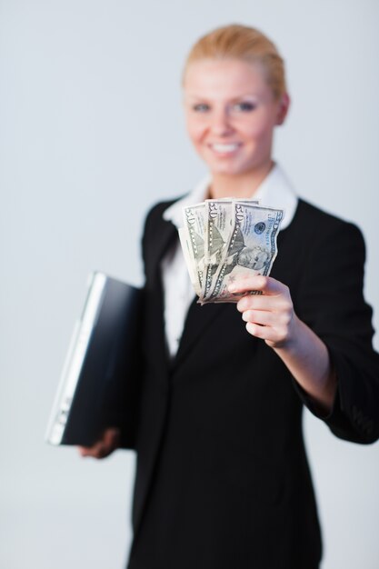 Woman with dollars and a laptop