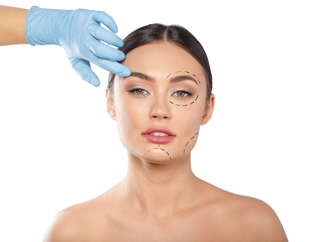 Woman with dotted lines on face, cosmetology