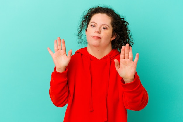 Photo woman with down syndrome isolated being shocked due to an imminent danger