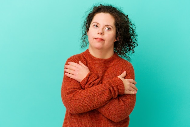 Woman with Down syndrome isolated hugs, smiling carefree and happy.