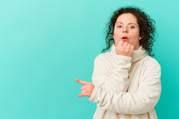 Woman with Down syndrome isolated pointing to the side