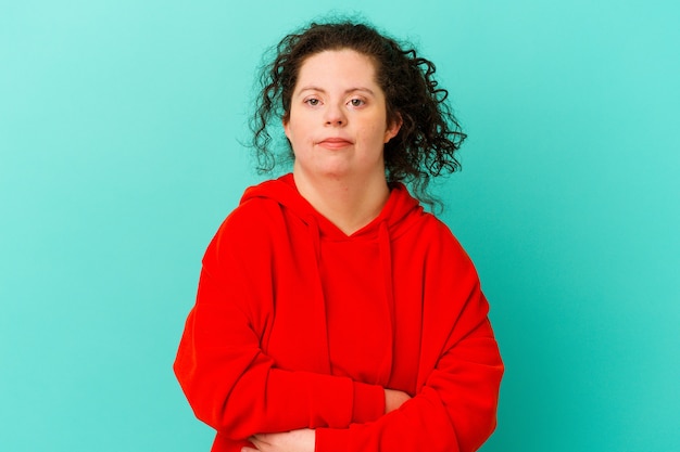 Woman with Down syndrome isolated unhappy looking in camera with sarcastic expression.