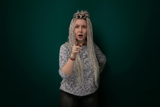 Woman with dreadlocks holding cell phone