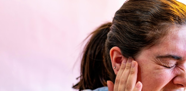 Photo woman with earache is holding his aching ear body pain concept