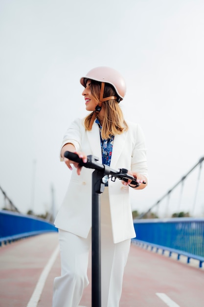 woman with electric scooter looking to the side