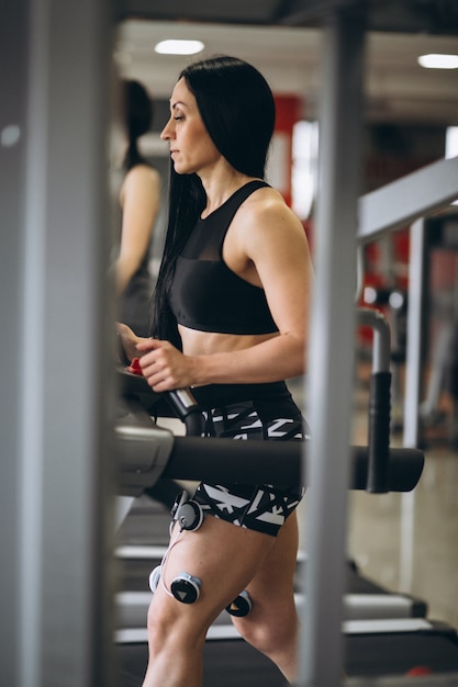 Woman with electrostimulator electrodes