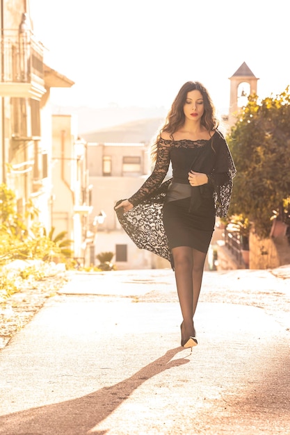 Woman with elegant black miniskirt walking in a sunny day