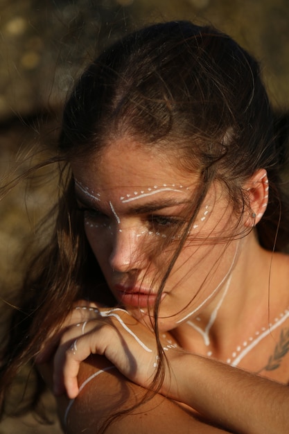 Woman with ethnic drawings on the body