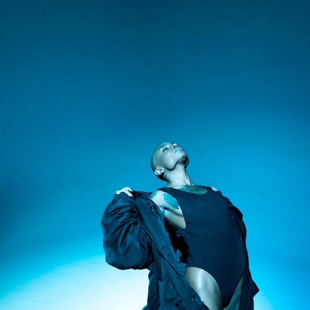 woman with eyes closed against blue background