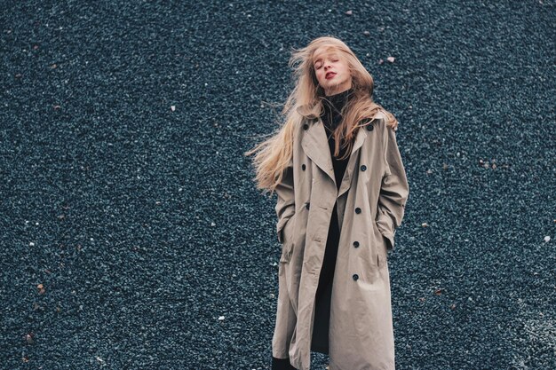 woman with eyes closed standing on stones