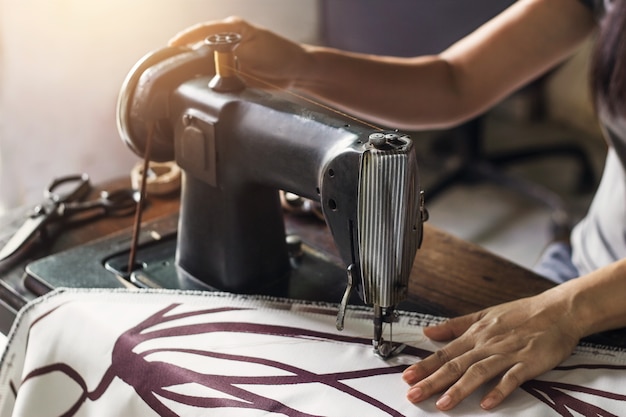  Woman with fabric at vintage sewing machine