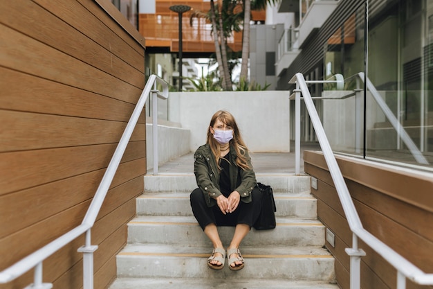 Woman with a face mask in public during coronavirus outbreak