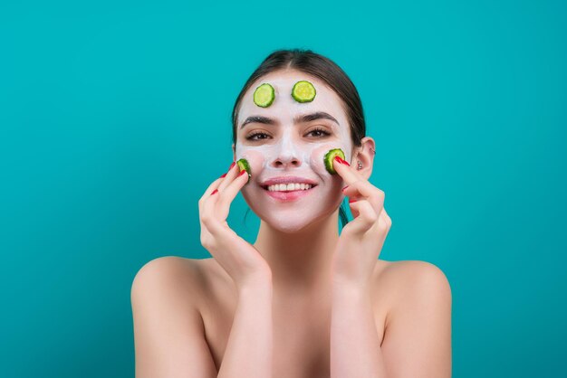 Woman with facial mask with slices of fresh cucumber on face cosmetic procedure beauty spa and cosme