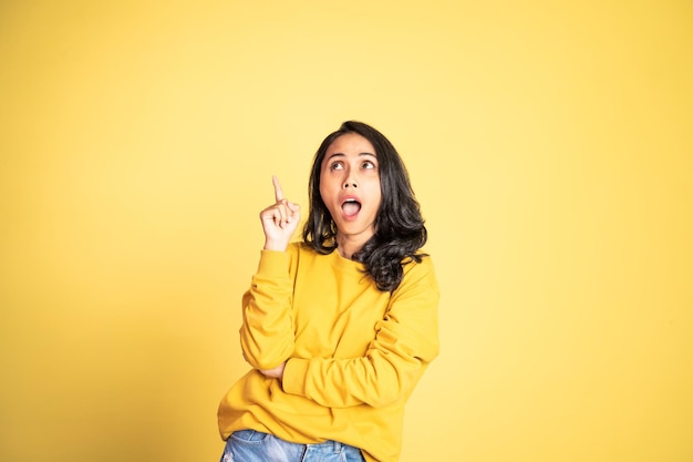 Woman with finger pointing up hand gesture on isolated background