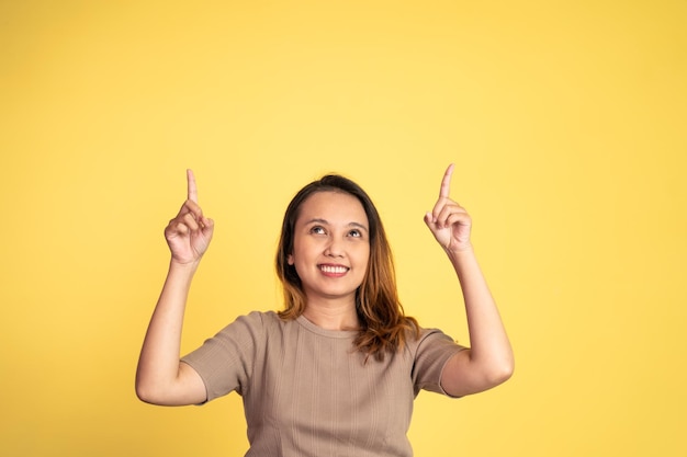 Woman with finger pointing up hand gesture on isolated background