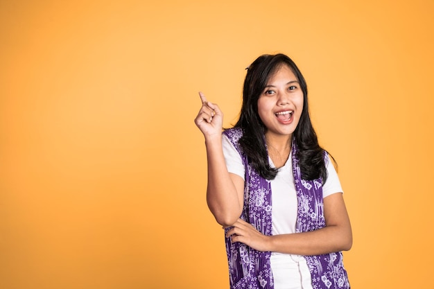 Woman with finger pointing up hand gesture on isolated background