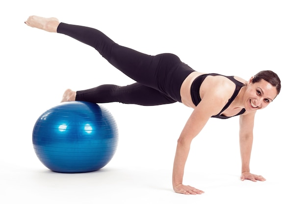 Woman with fitball doing push-ups