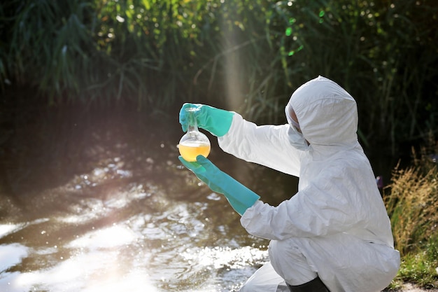 Woman with flask for expertise Environmental pollution concept