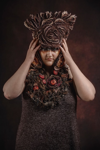 Woman with floral hat on a dark room