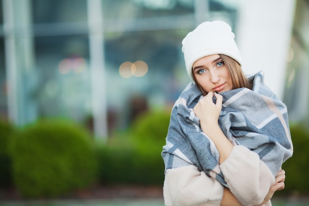 Woman with flu outdoors wearing a scarf