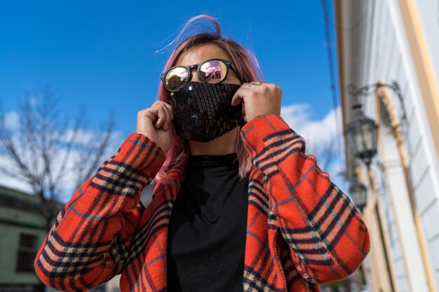 Woman with foot mask standing on a scenic sidewalk in the city