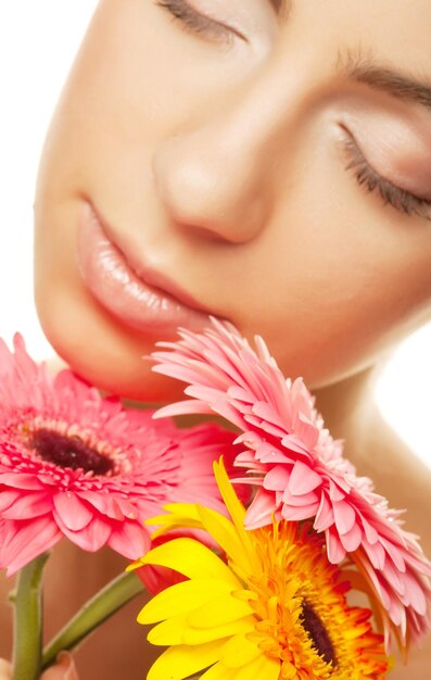 Woman with gerber flower isolated on white background