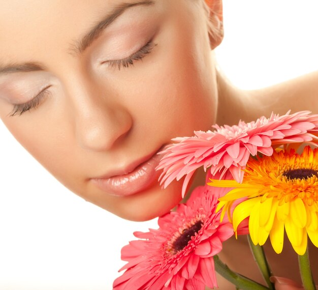 Woman with gerber flower isolated on white background