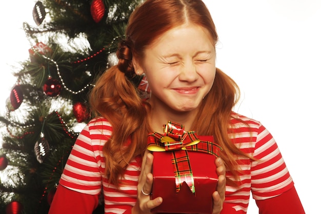 Woman with gift box and christmas tree