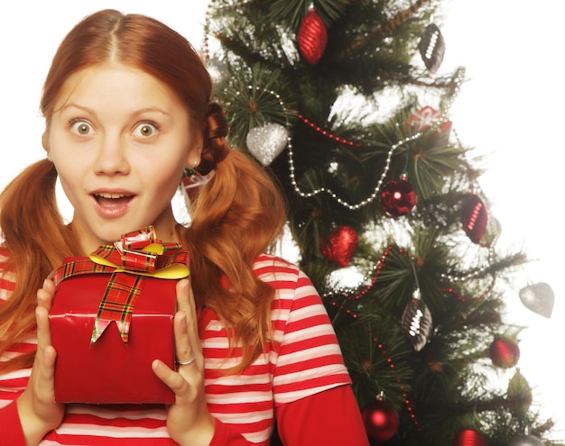 Woman with gift box and christmas tree