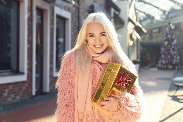 Woman with gift box on street