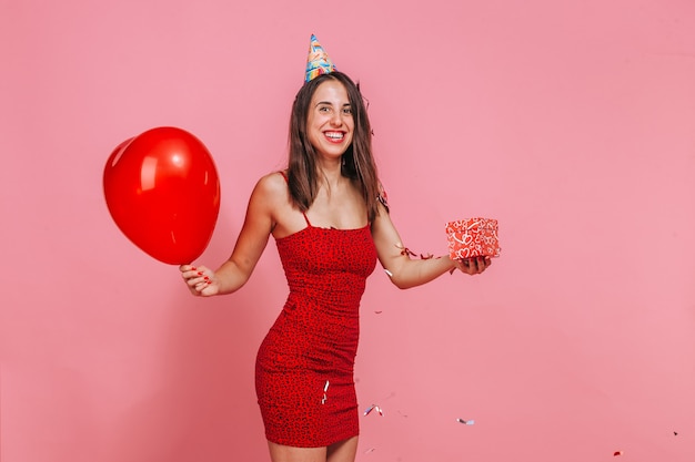 The woman with a gift. Pink wall