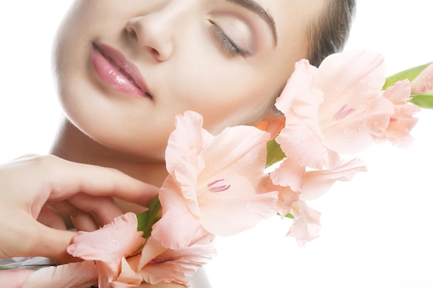 Woman with gladiolus flowers in her hands